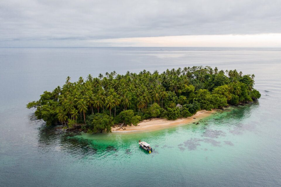 Clear lagoon waters and tropical shore at a Madang island